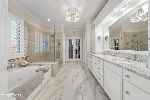 full bathroom featuring double vanity, a sink, a shower stall, crown molding, and a jetted tub