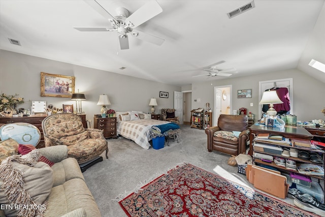 carpeted bedroom with vaulted ceiling, visible vents, and ceiling fan