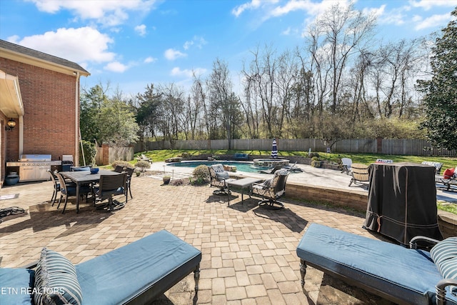 view of patio featuring outdoor dining space, a fenced backyard, a fenced in pool, and a grill