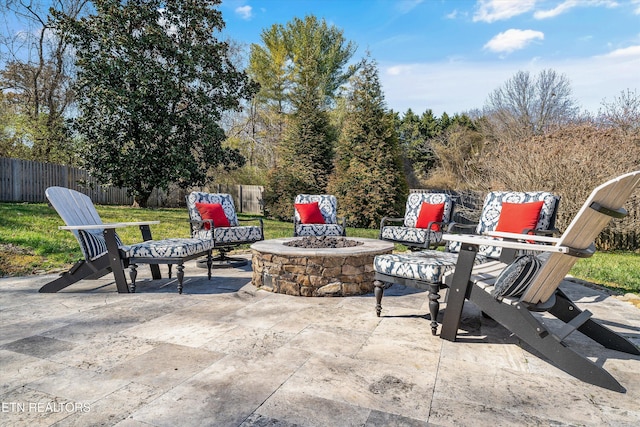 view of patio featuring fence private yard and a fire pit