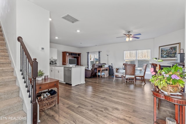 living room with hardwood / wood-style flooring and ceiling fan