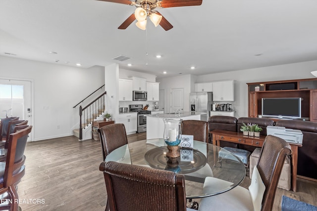 dining room with ceiling fan and light wood-type flooring