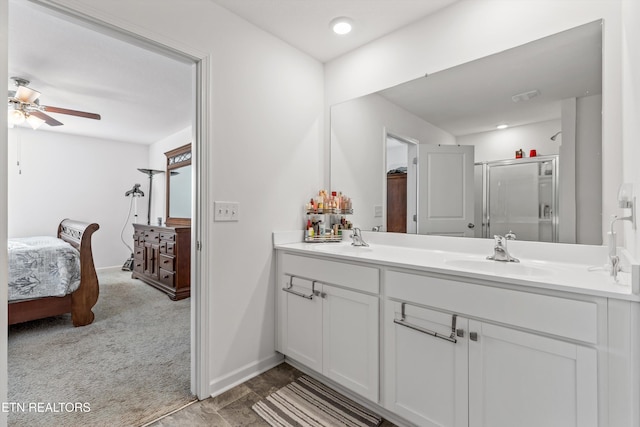 bathroom featuring a shower with door, vanity, and ceiling fan