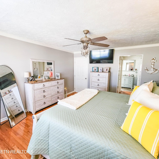 bedroom with ceiling fan, wood-type flooring, a textured ceiling, and ornamental molding