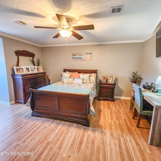 bedroom with crown molding, ceiling fan, light hardwood / wood-style flooring, and a textured ceiling