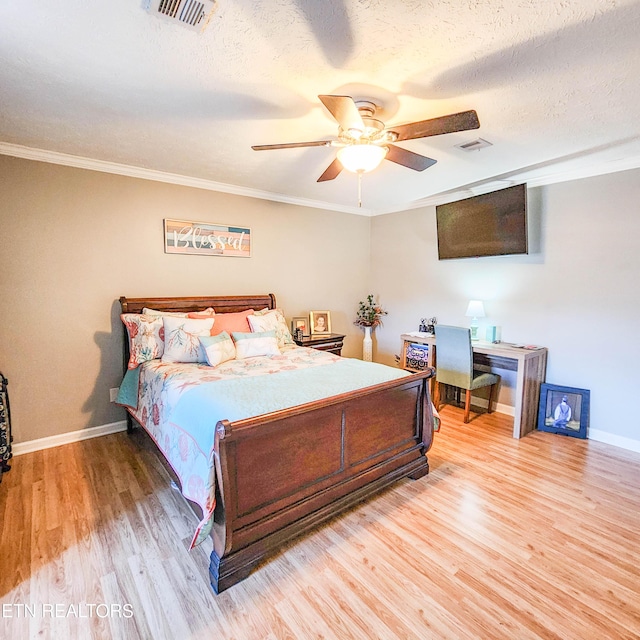 bedroom with wood-type flooring, ornamental molding, a textured ceiling, and ceiling fan