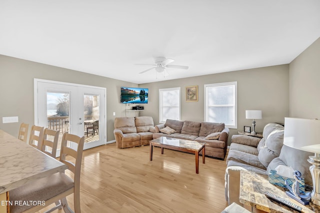 living room with a wealth of natural light, ceiling fan, and light wood-type flooring