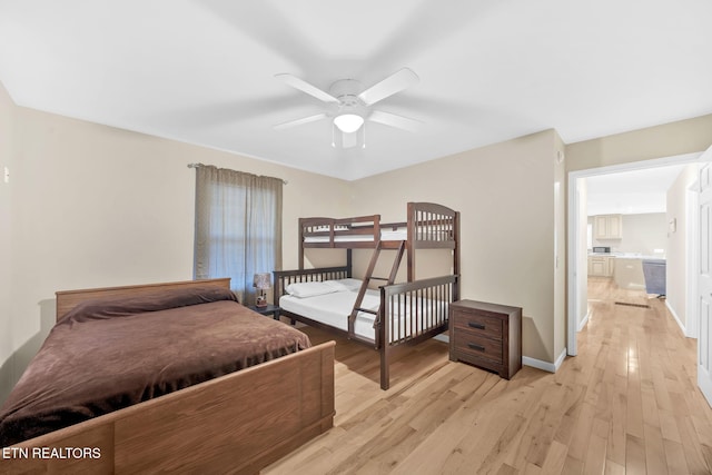 bedroom featuring ceiling fan, light hardwood / wood-style floors, and ensuite bathroom