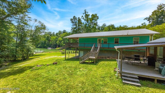 1429 Sunbeam Ln, Dandridge, TN 37725 - view of front of house featuring a deck, stairs, a front yard, and a metal roof