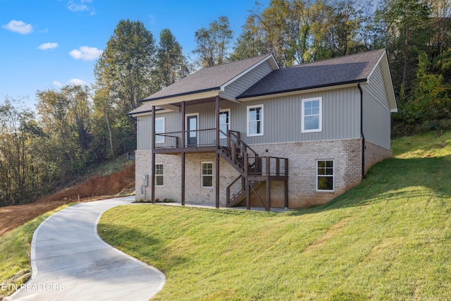 view of front of house featuring a front yard, stairway, and brick siding