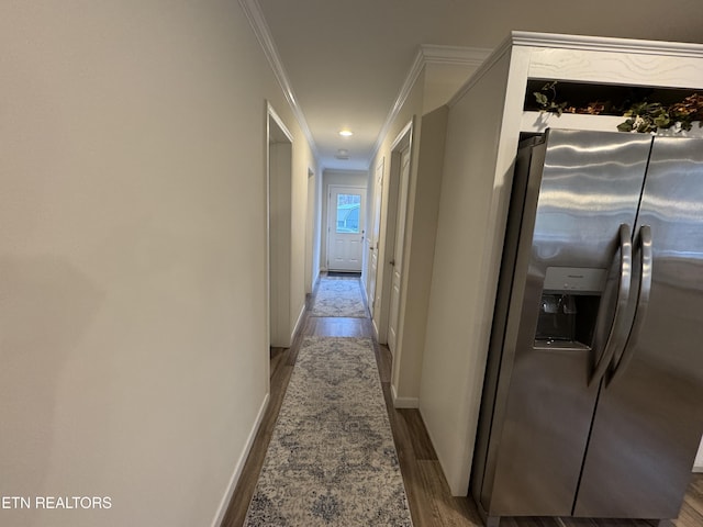 hallway featuring hardwood / wood-style floors and ornamental molding