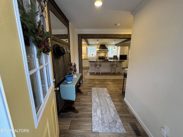 hall with dark hardwood / wood-style flooring and ornamental molding