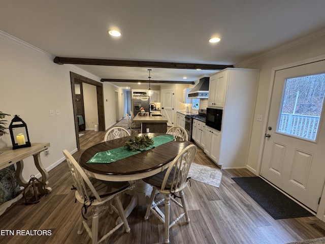 dining area featuring crown molding, sink, beamed ceiling, and dark hardwood / wood-style floors