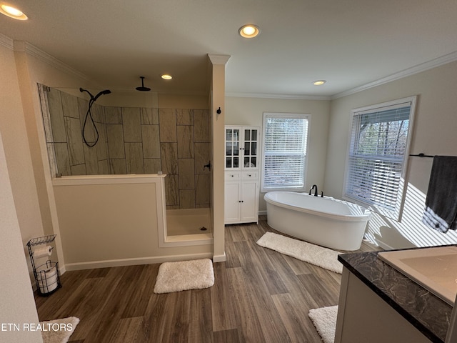 bathroom with hardwood / wood-style floors, vanity, crown molding, and shower with separate bathtub