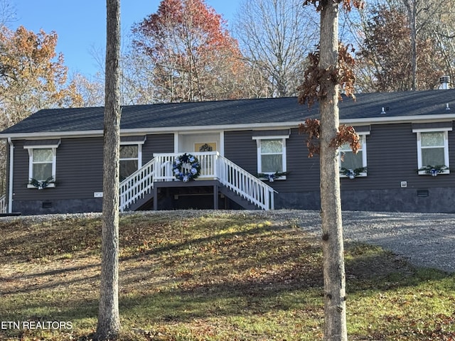 view of front of house with a deck and a front lawn