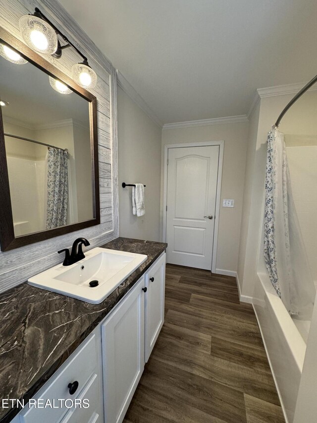 bathroom featuring shower / bath combination with curtain, vanity, wood-type flooring, and ornamental molding