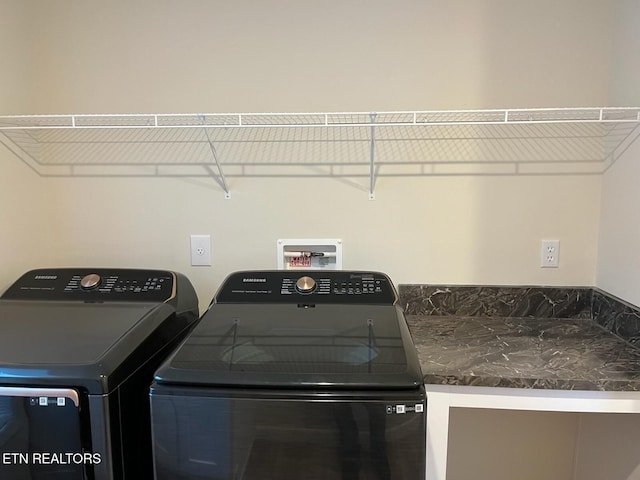 clothes washing area with washing machine and clothes dryer