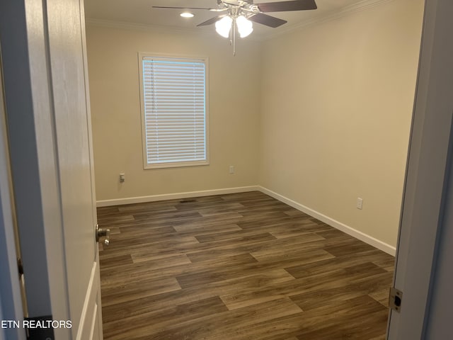 empty room featuring crown molding, dark hardwood / wood-style flooring, and ceiling fan