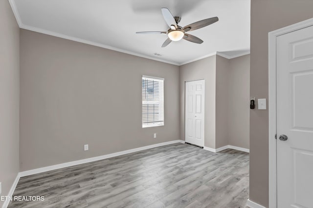 interior space with light hardwood / wood-style floors, ceiling fan, and crown molding