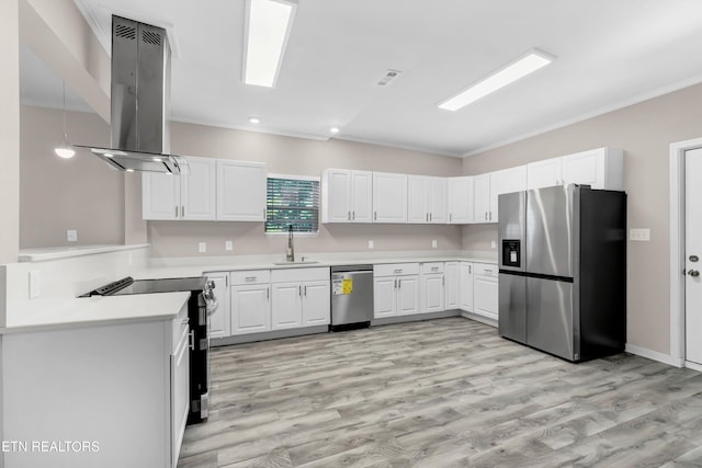 kitchen with wall chimney exhaust hood, white cabinets, light hardwood / wood-style floors, and appliances with stainless steel finishes