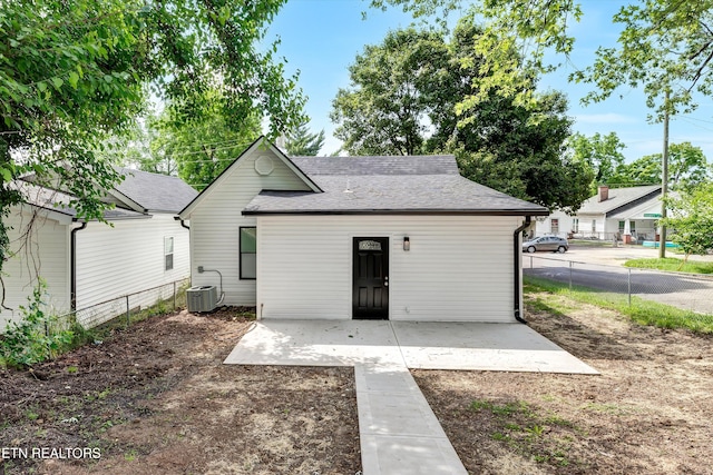 rear view of property with a patio and central AC