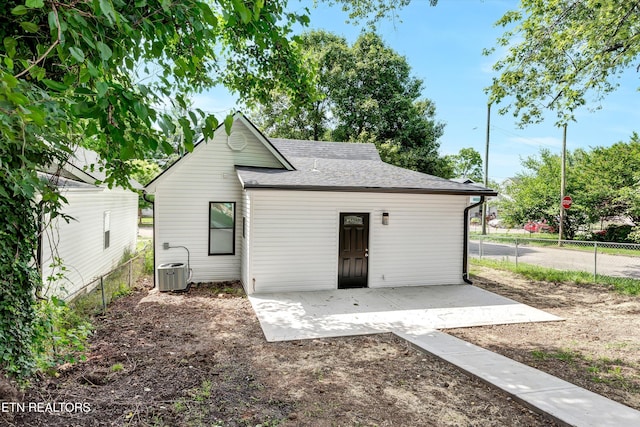 back of property featuring cooling unit and a patio