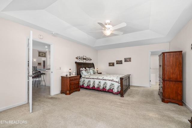 bedroom with light carpet, a raised ceiling, and ceiling fan