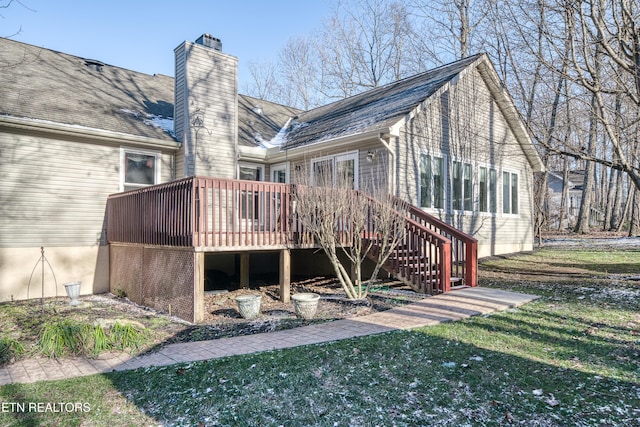 back of house with a lawn and a deck