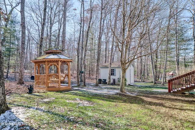 view of yard with a gazebo and a storage shed