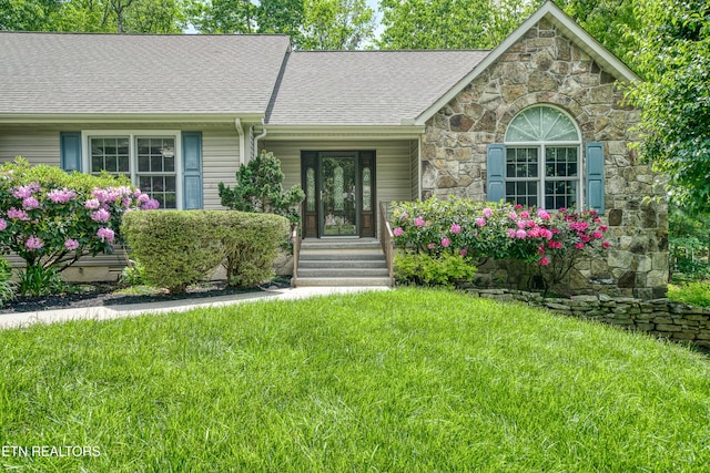 55 Loxley Ln, Crossville, TN 38558 - view of front facade featuring stone siding, a front lawn, and roof with shingles
