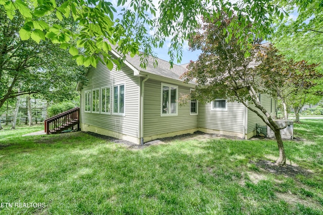 55 Loxley Ln, Crossville, TN 38558 - view of home's exterior featuring a lawn, stairs, and roof with shingles