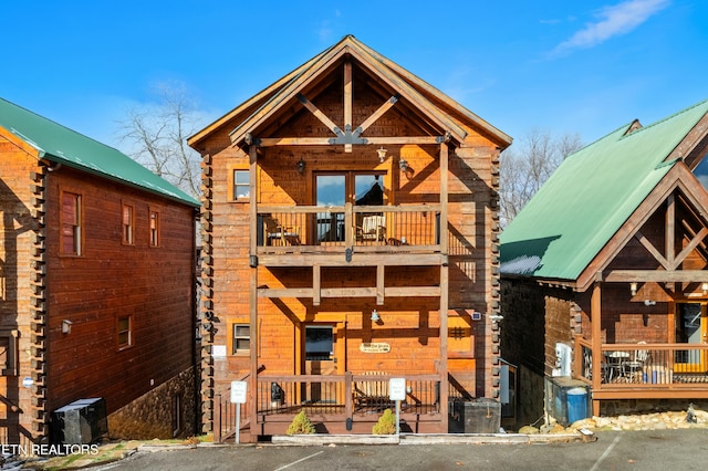 rear view of property featuring a balcony