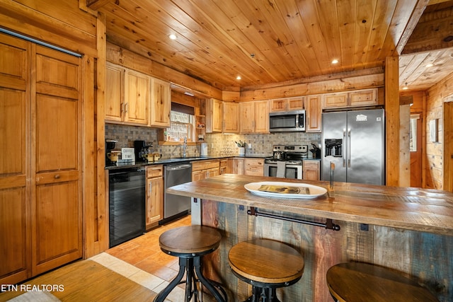 kitchen with butcher block counters, decorative backsplash, beverage cooler, and stainless steel appliances