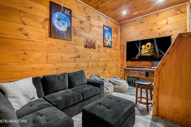 living room with carpet flooring, wood ceiling, and wooden walls