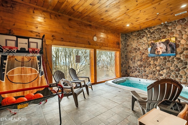 interior space featuring wood walls, wood ceiling, and a hot tub