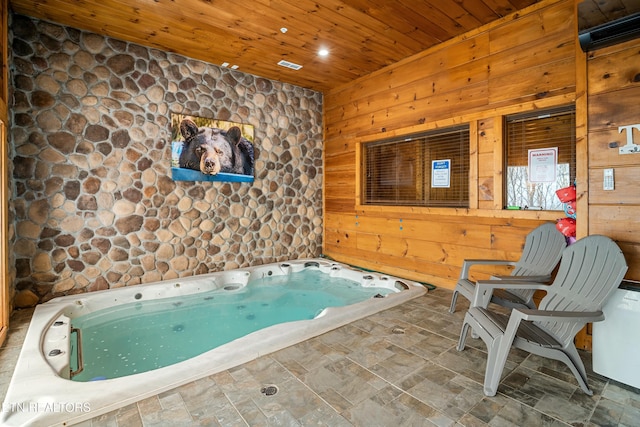 view of pool with an indoor hot tub