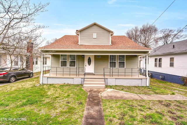 bungalow-style home with a porch and a front lawn