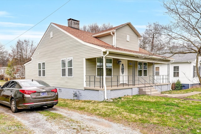 view of front of property with covered porch and a front lawn