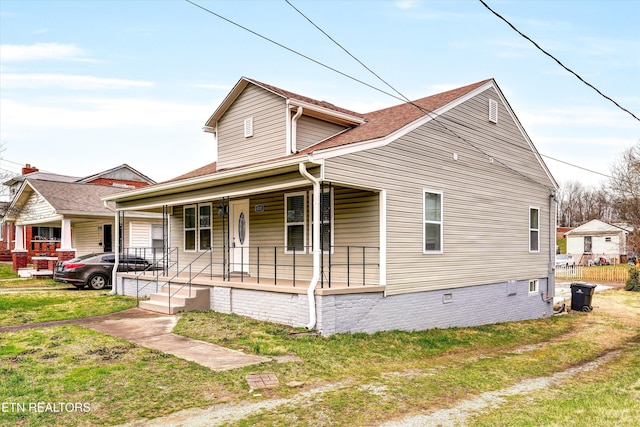 view of front of home featuring a front lawn and covered porch