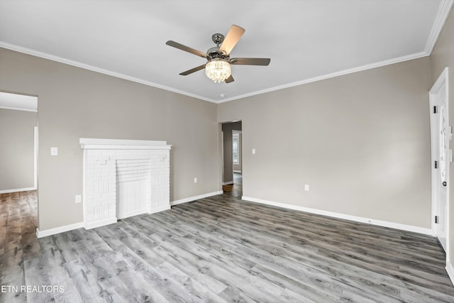 unfurnished bedroom with a fireplace, hardwood / wood-style floors, ceiling fan, and crown molding