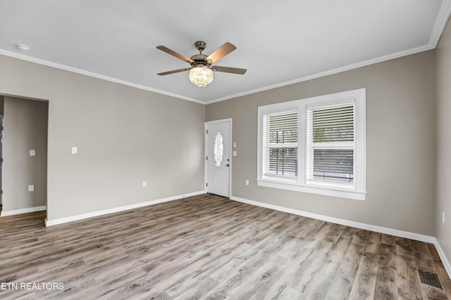 interior space with ceiling fan, light wood-type flooring, and ornamental molding