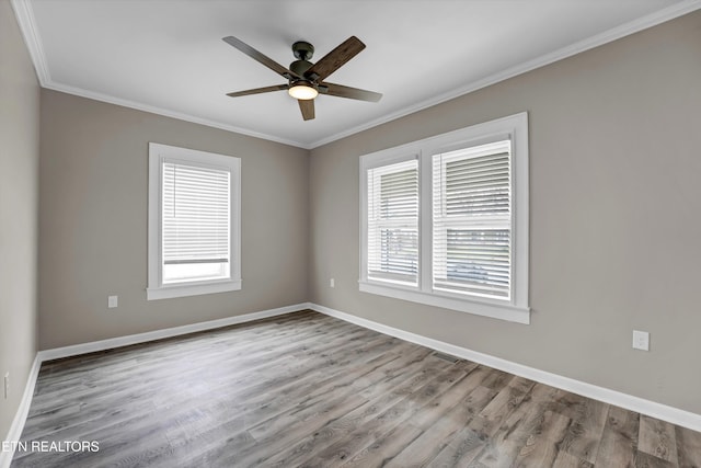 unfurnished room with light hardwood / wood-style floors, a wealth of natural light, crown molding, and ceiling fan