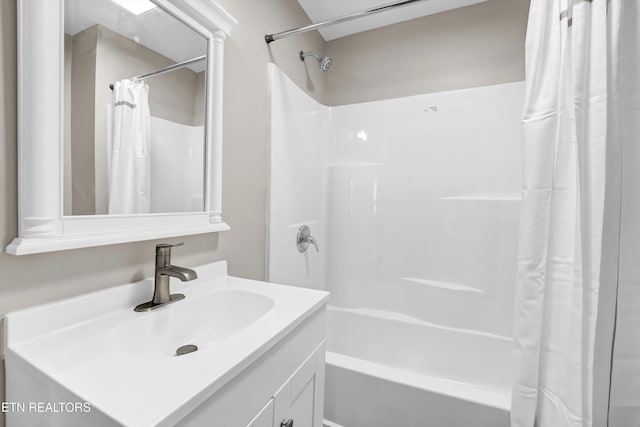 bathroom featuring vanity and shower / bathtub combination with curtain