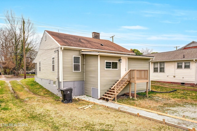 back of property with a lawn