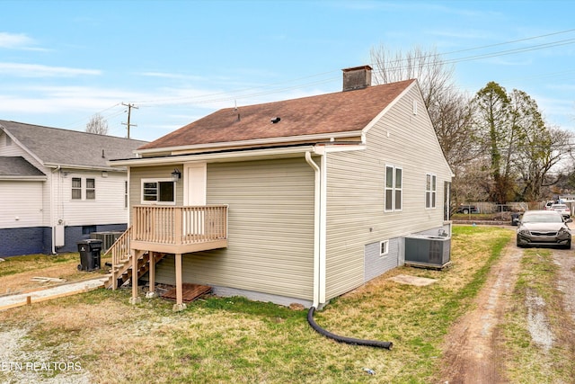 exterior space with a lawn and cooling unit