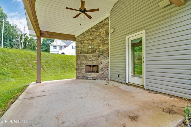 view of patio / terrace with ceiling fan and an outdoor stone fireplace