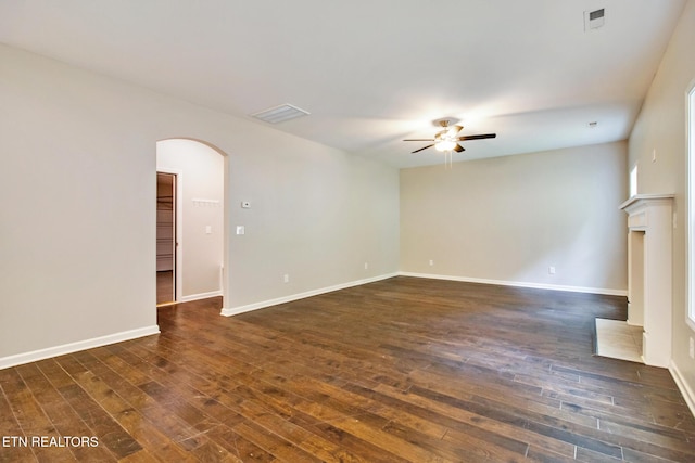 unfurnished living room featuring ceiling fan and dark wood-type flooring