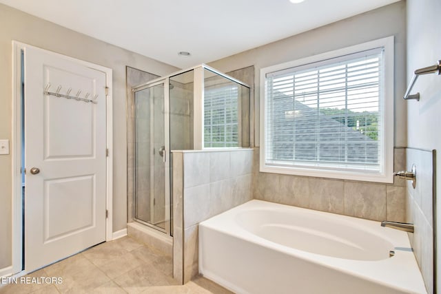 bathroom featuring tile patterned floors and separate shower and tub