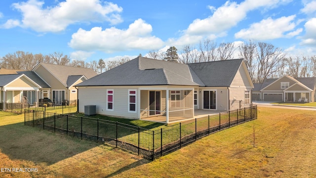 back of house with central AC, a sunroom, and a yard