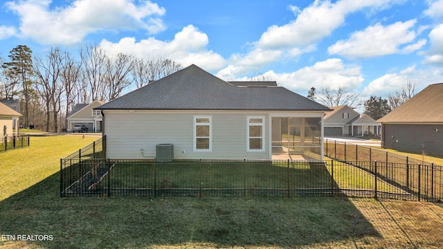 back of property with a sunroom and a lawn